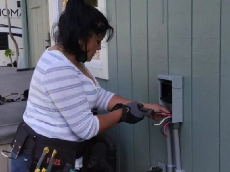 Licensed electrician wiring an exterior subpanel in New Bedford